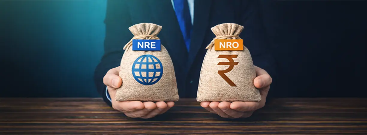 A hand placing coins into a white piggy bank on a table to represent investment savings by ICICI Bank